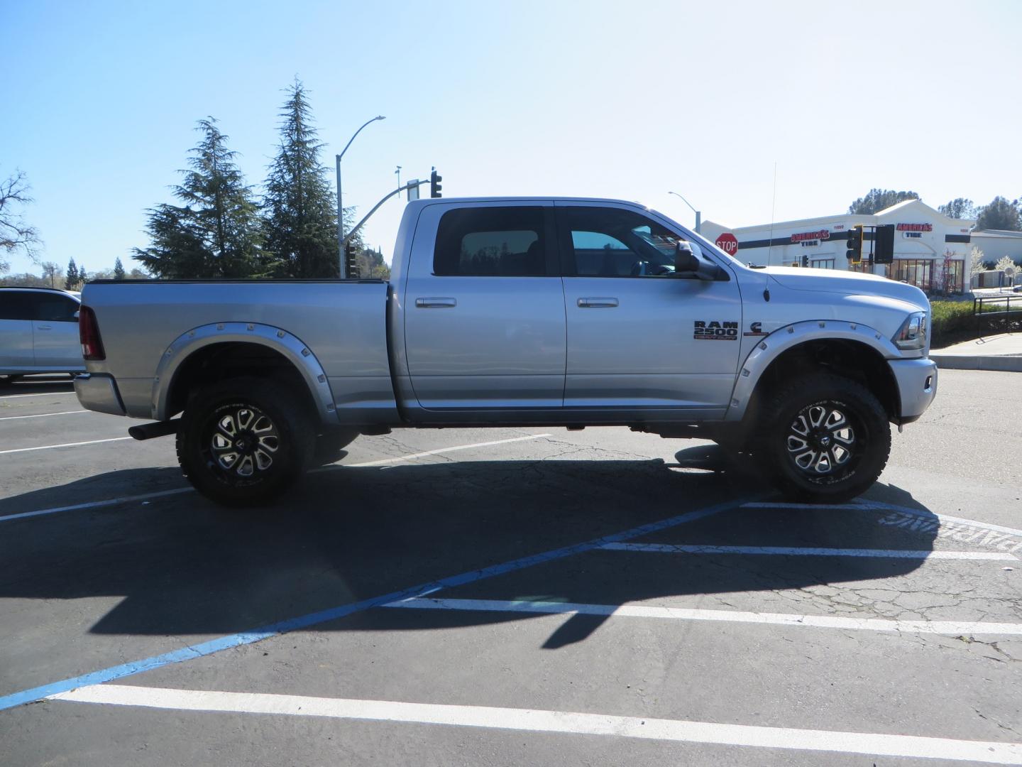 2016 SILVER /BLACK RAM 2500 Laramie Crew Cab SWB 4WD (3C6UR5FL3GG) with an 6.7L L6 OHV 24V TURBO DIESEL engine, 6A transmission, located at 2630 Grass Valley Highway, Auburn, CA, 95603, (530) 508-5100, 38.937893, -121.095482 - Leveled Ram sitting on Fuel Offroad wheels, Falken Wildpeak AT tires, Amp Power steps, Rolling Bed cover, Color matched fender flares, and window tint. - Photo#3